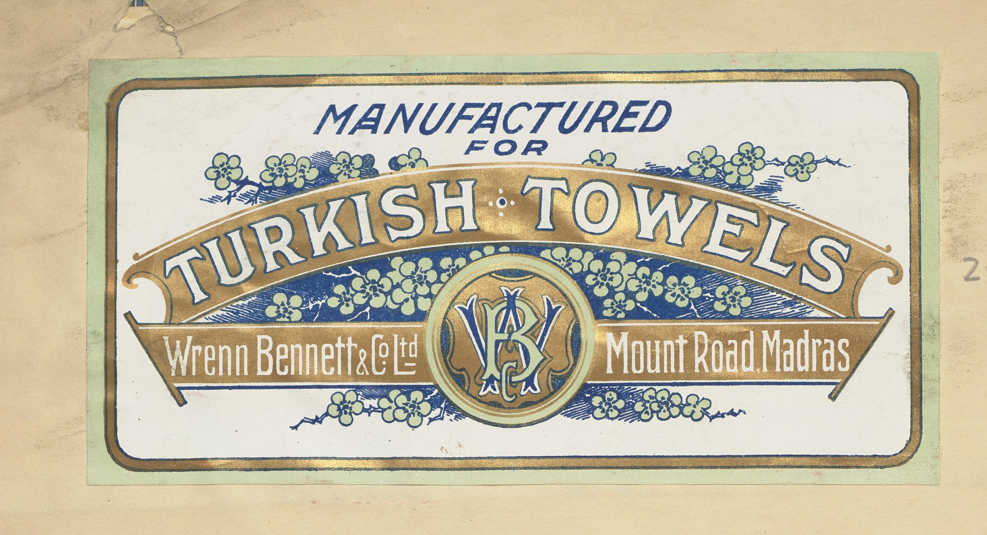 A blue and gold label, featuring the name Wrenn Bennett & Co. and their location in Madras.